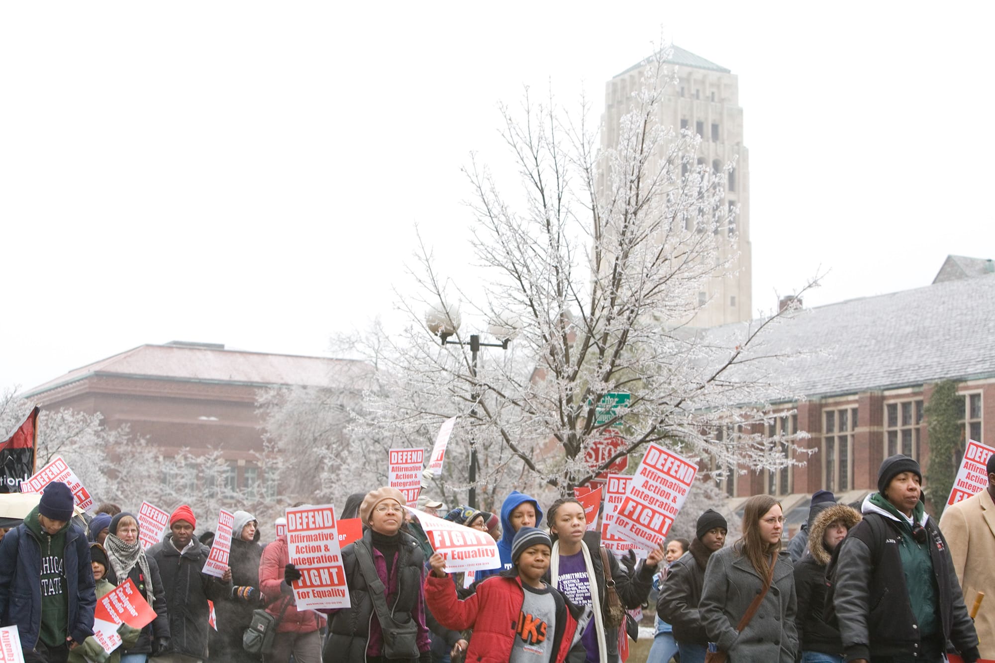 Demonstrators march through the streets of Ann Arbor holding signs that read "Defend Affirmative Action and Integration. Fight for Equality."