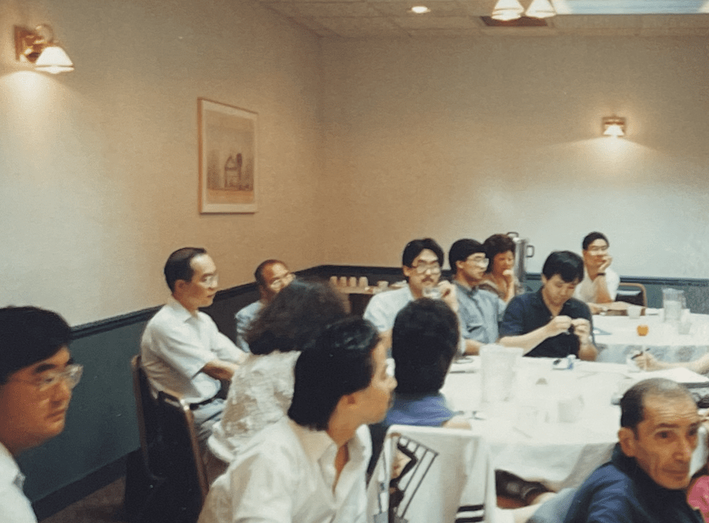 People sitting at banquet tables at an American Citizens for Justice event.
