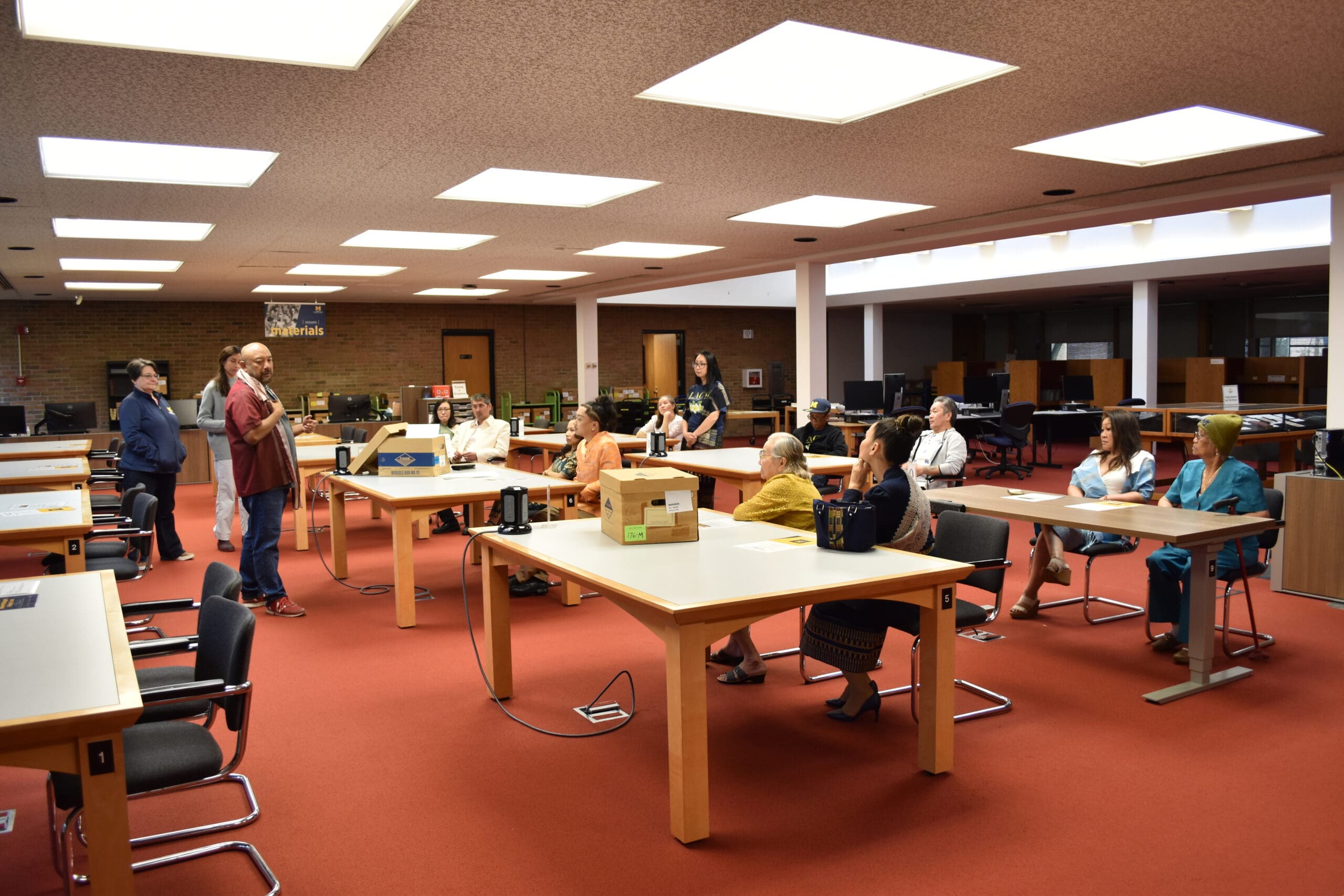 Members of the Lao American Community of Michigan sitting in the Bentley Reading Room.