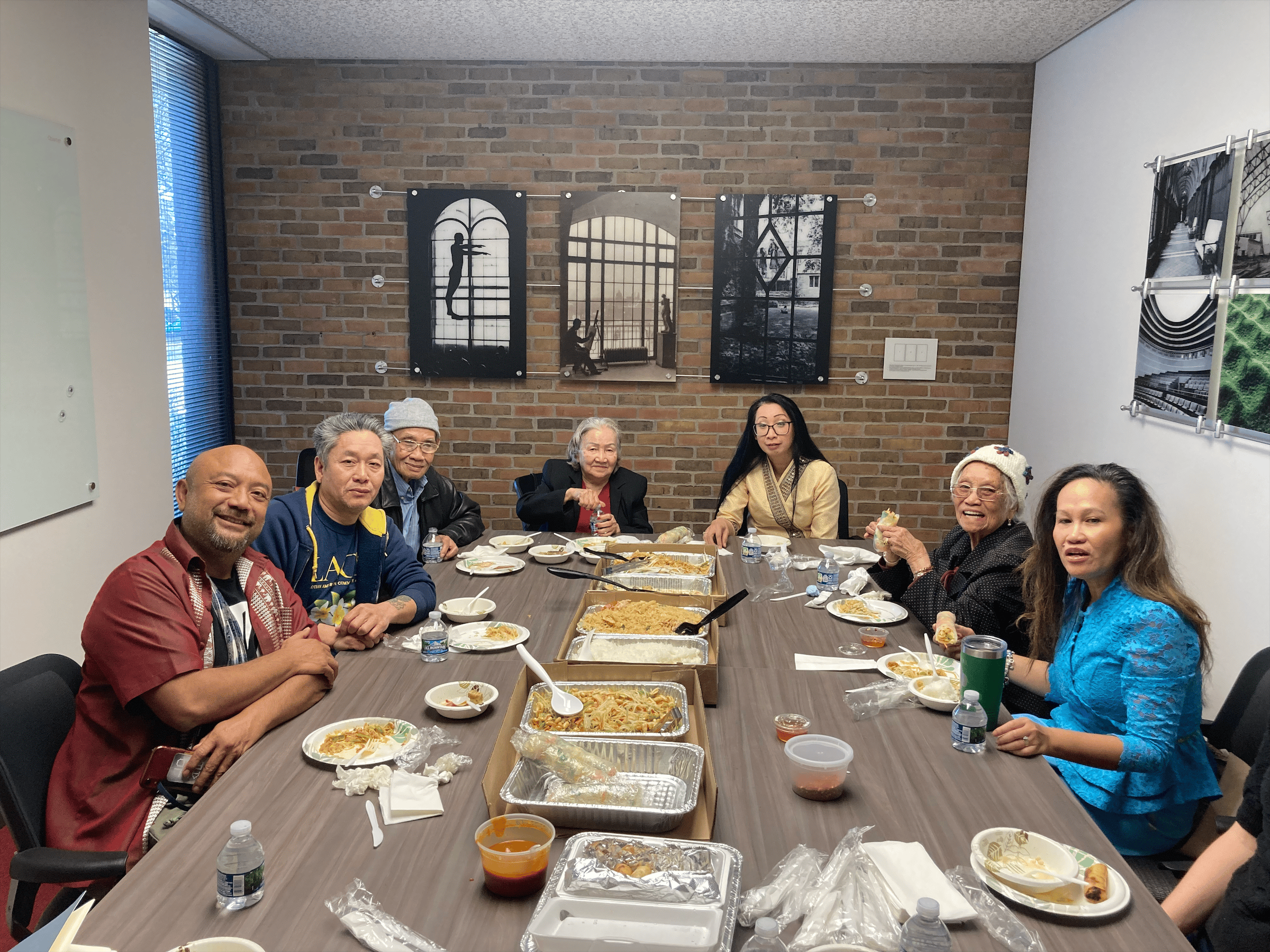 Generations of Lao Americans sitting at a table and eating lunch in the Bentley Historical Library.