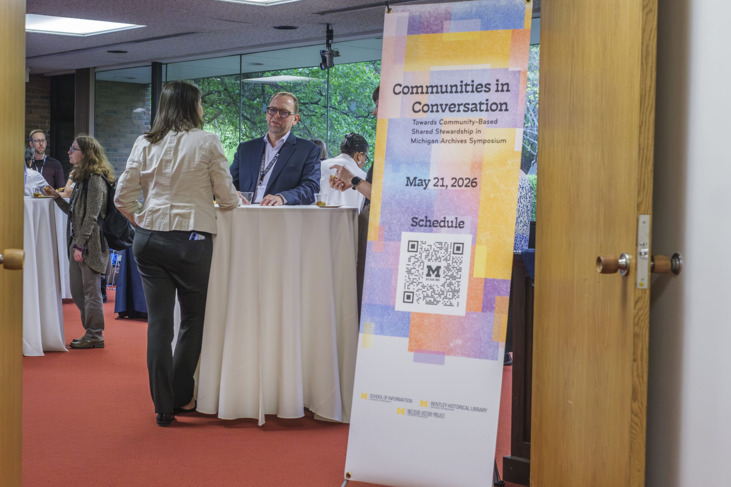 Attendees of the Communities in Conversation Symposium reception at the Bentley Historical Library.