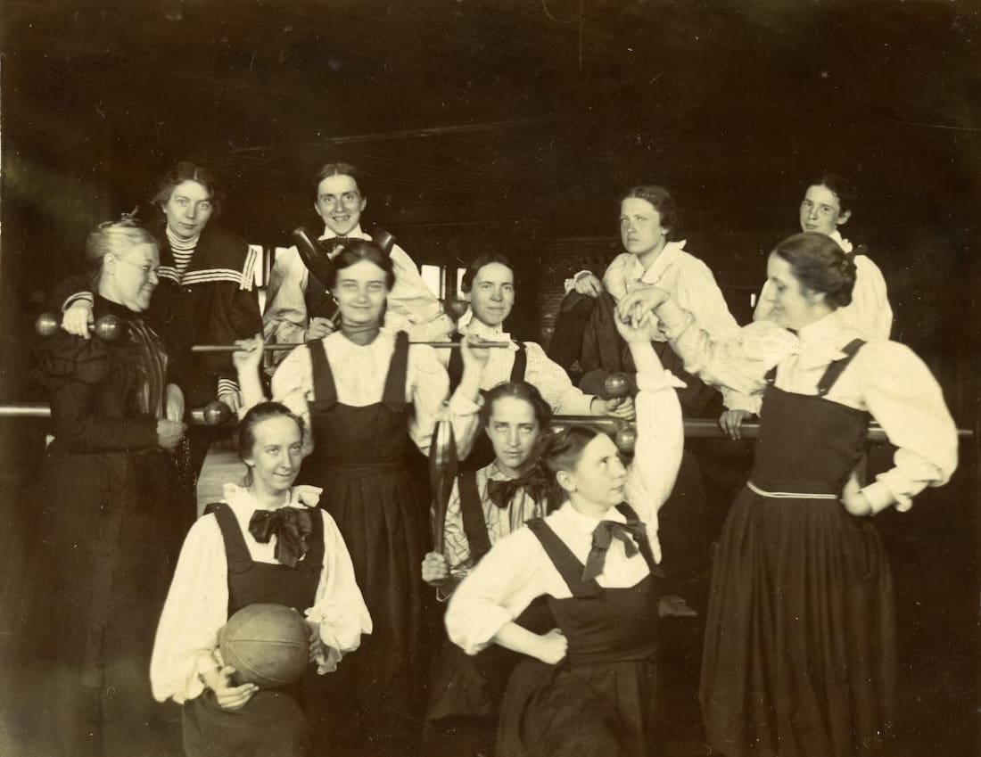 Group of women holding exercise equipment.