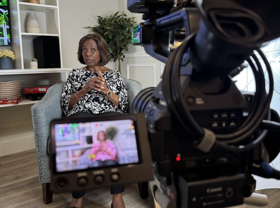 Dr. Blenda Wilson sitting in front of a camera during her interview.
