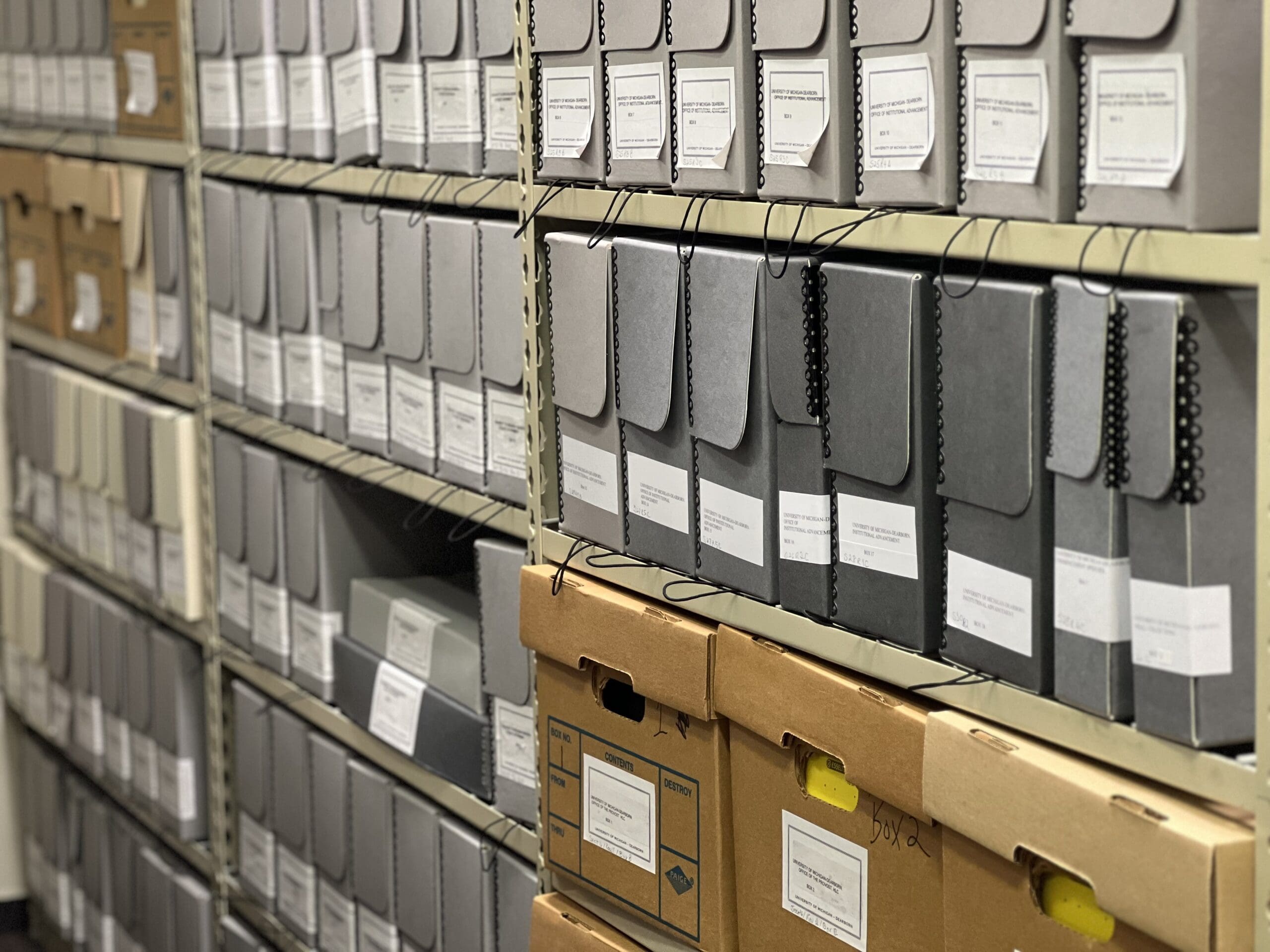 Shelves of archival boxes in the UM-Dearborn campus archive.