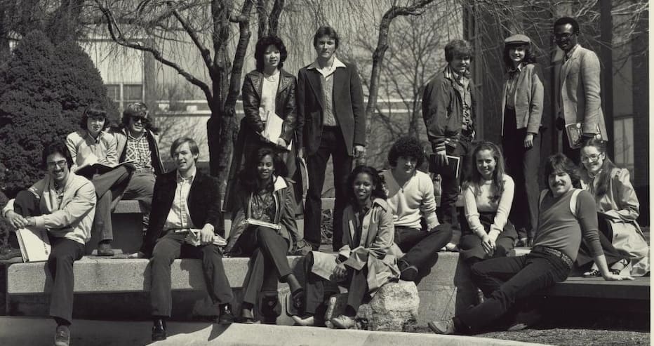 Group of Students posed at the edge of the Chancellor's Pond at UM-Dearborn.