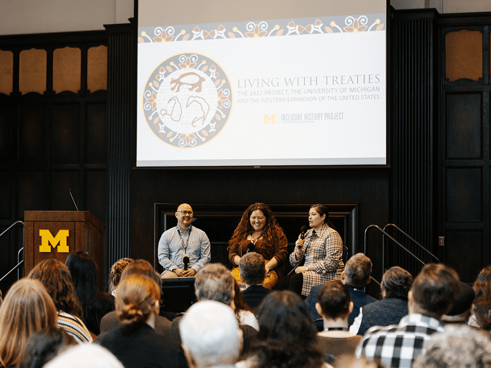 Panelists seated on stage for the "On the Hidden Histories of Public Domain Land" panel.