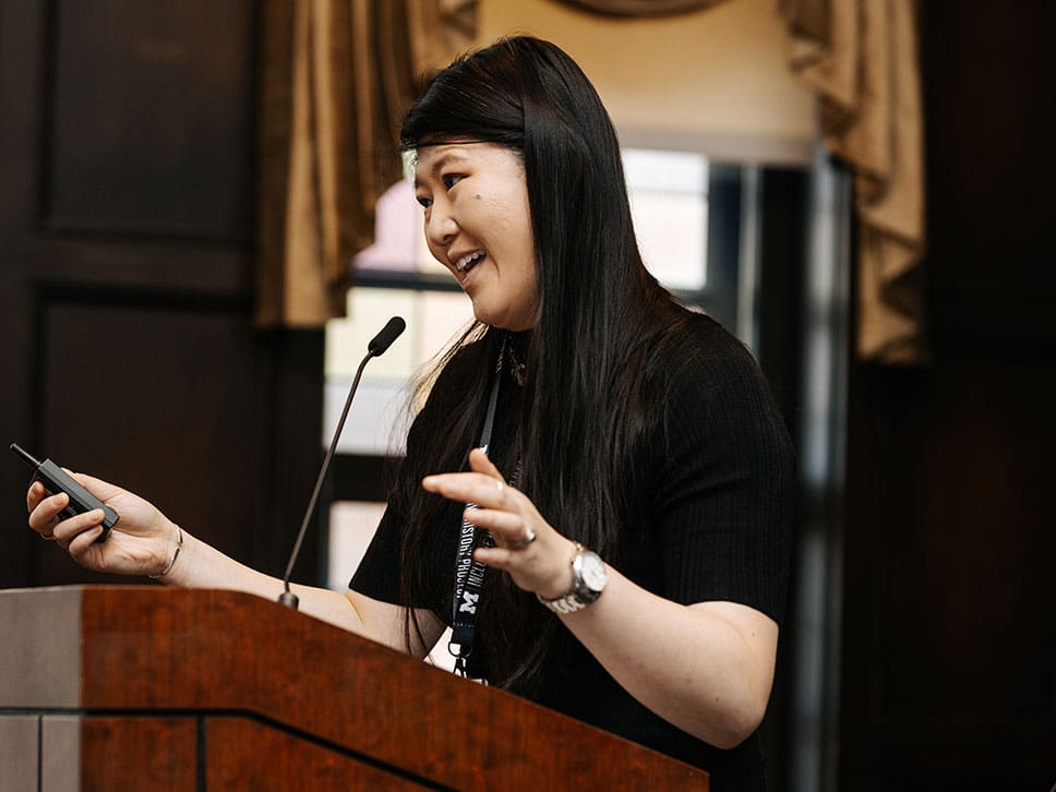 Panelist Mary Shi speaks at the podium for the "Universities and Indigenous Dispossession" panel.