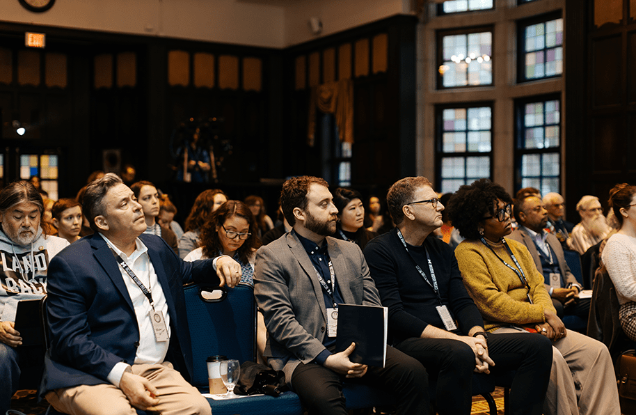 Panelists seated among the audience.