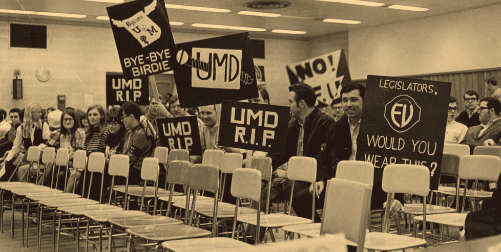 Dozens of students holding signs that read “UMD R.I.P.” and “Bye-Bye Birdie.”