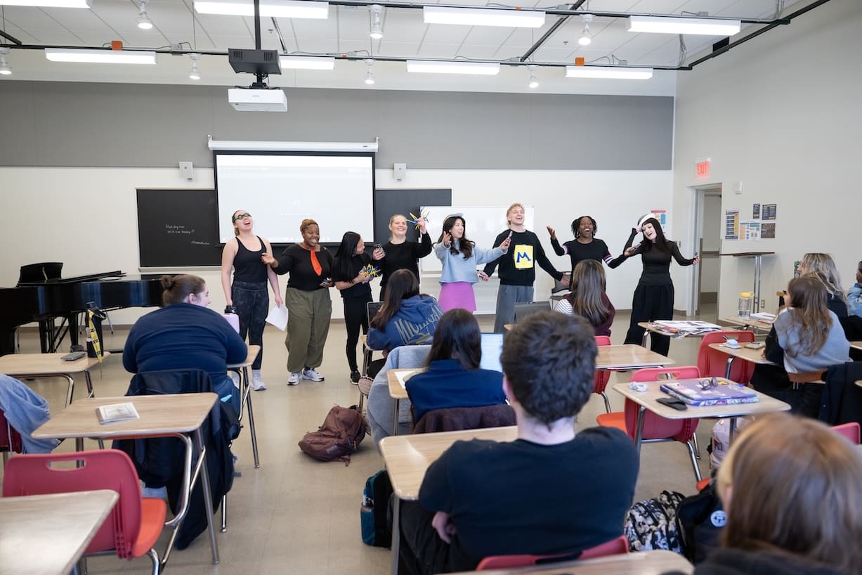 Students present projects in a classroom.